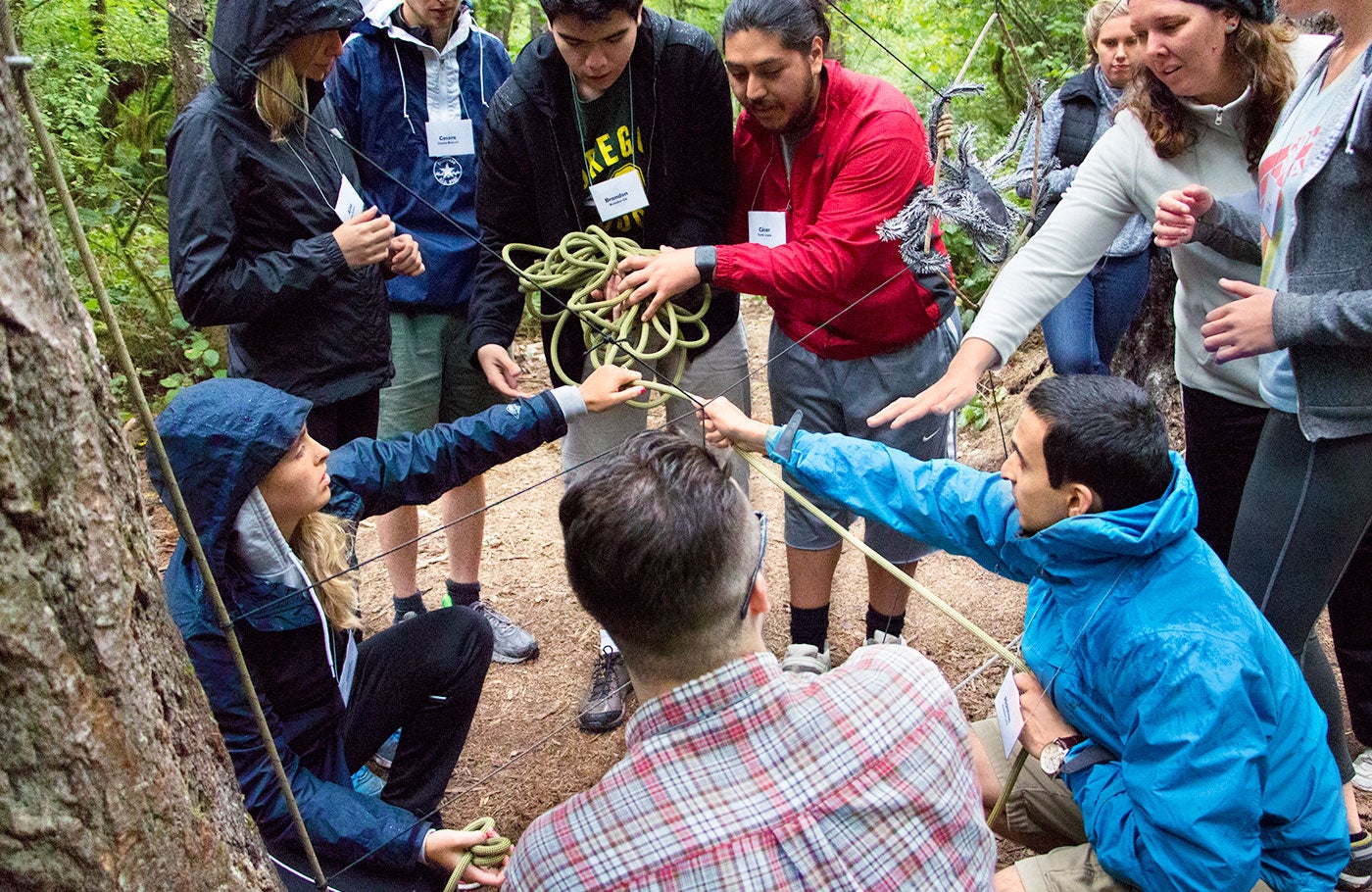 Students working as a team to create a structure from rope.