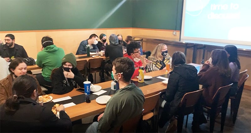 Students discuss politics over pizza